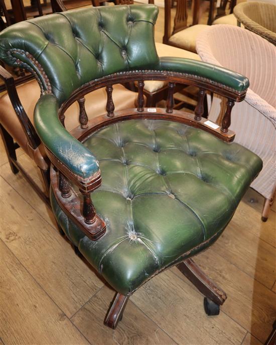 A mahogany and green leather desk chair
